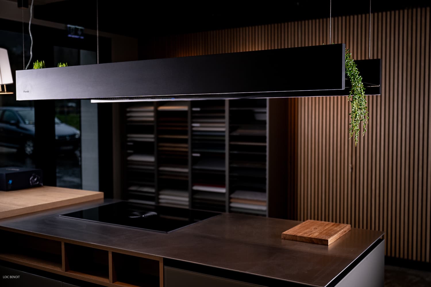 Showroom de cuisine avec rangements ouverts et finition bois sombre